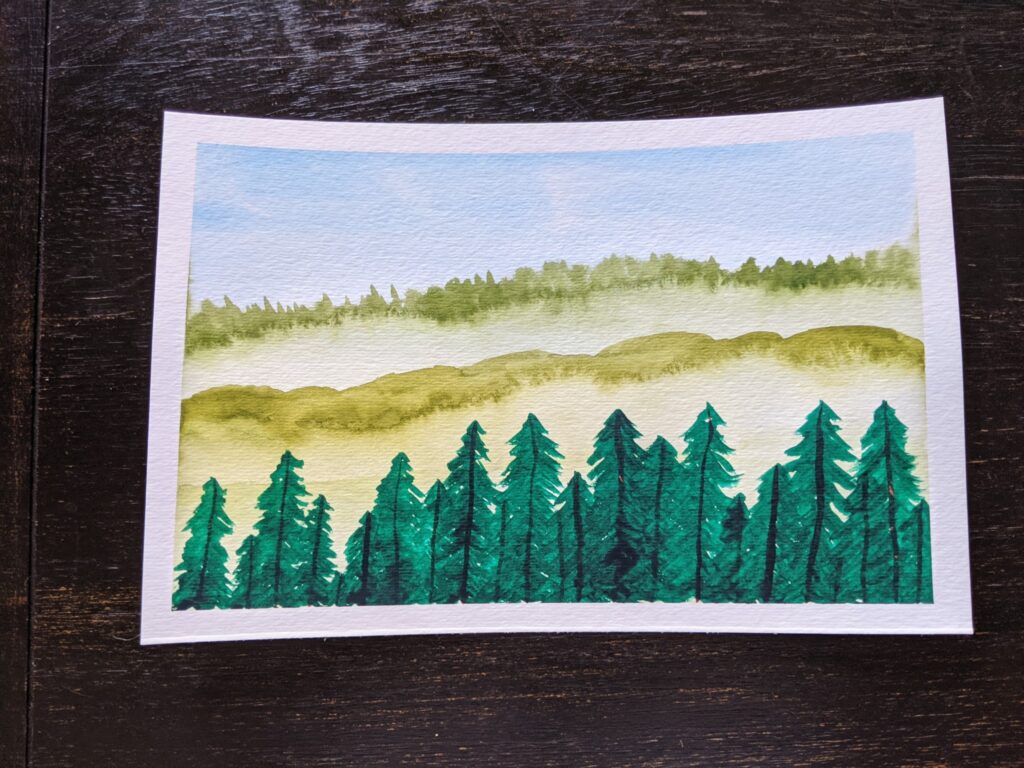 A watercolor painting of light blue sky and soft green hills filled with pine trees. 